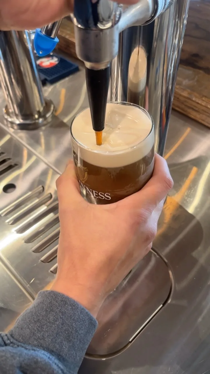 A pint of Guinness being poured at the tap